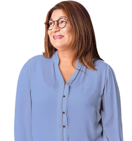 Hispanic woman with shoulder length brown hair and glasses looking to her left at the Medicare Advantage header and smiling. Wearing a long-sleeve, v-neck, blue blouse.