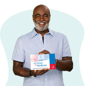 African American man with light blue shirt holding Get Ready for Medicare pamphlet