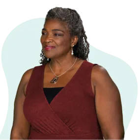 African American woman in a dark red dress looking left
